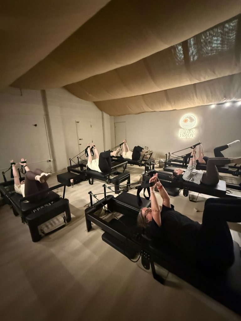 People taking a Reformer Pilates class at Bay & Body Studios, Scarborough